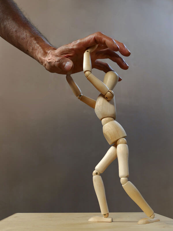 hand-abuse hand over a wooden dummy